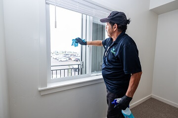 Moonshine employee wiping windows for post construction cleaning in Blackfoot