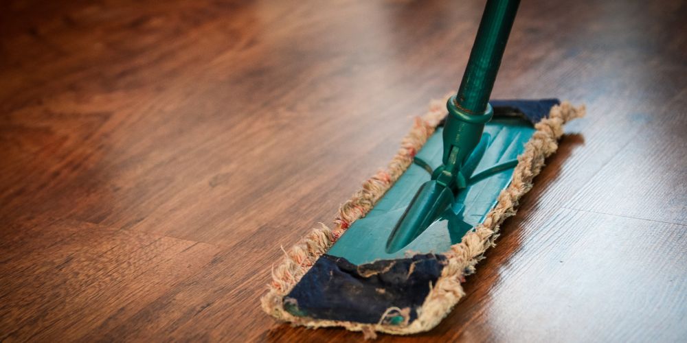 Commercial hardwood floor being cleaned with a microfiber mop