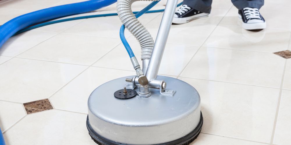 Commercial tile floor and grout being cleaned with a floor scrubber